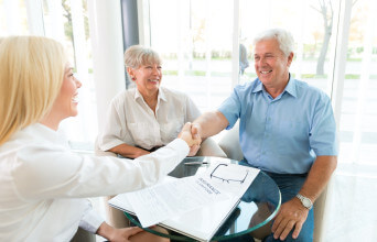 Senior Couple Shaking Hand With Insurance Agent